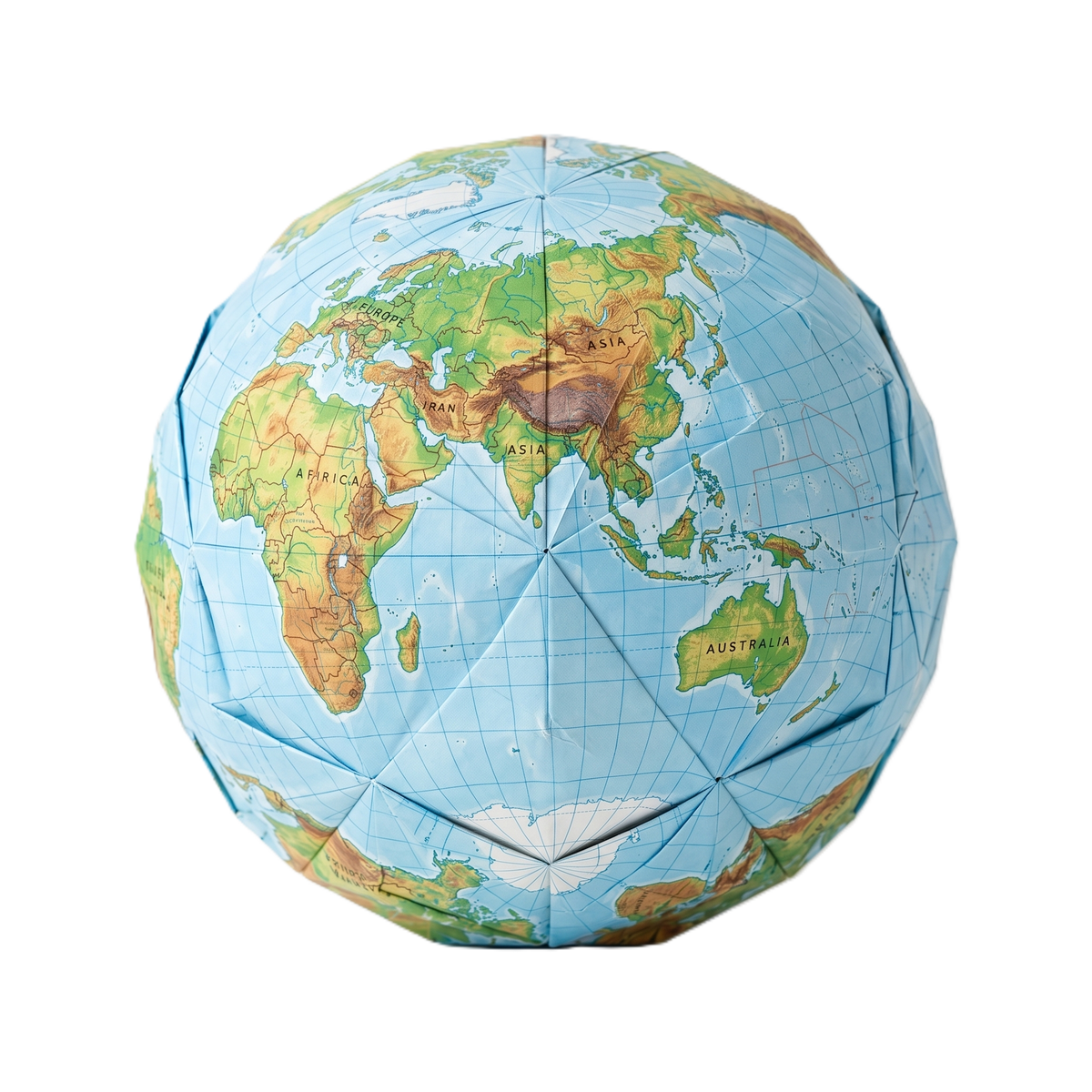 Origami globe folded in pale paper on a warm cream background